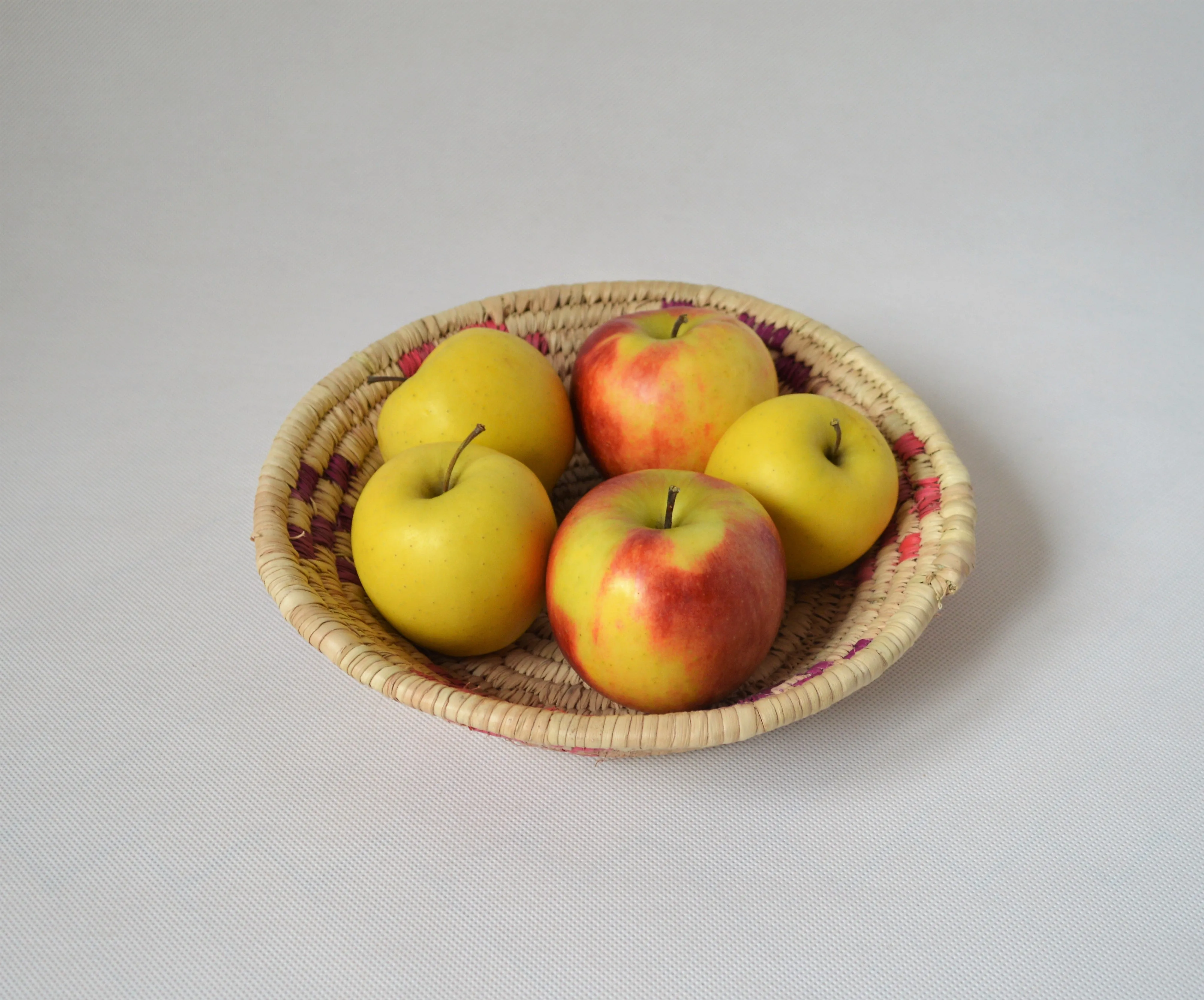 Handmade round fruit and bread bowl from palm straw